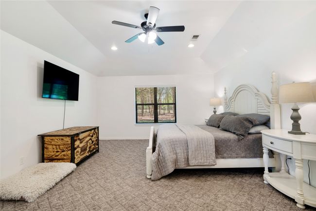 Bedroom featuring carpet flooring, baseboards, visible vents, recessed lighting, and a ceiling fan | Image 11