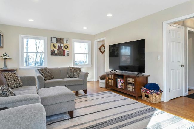 Living room with door to lower level in view. | Image 15