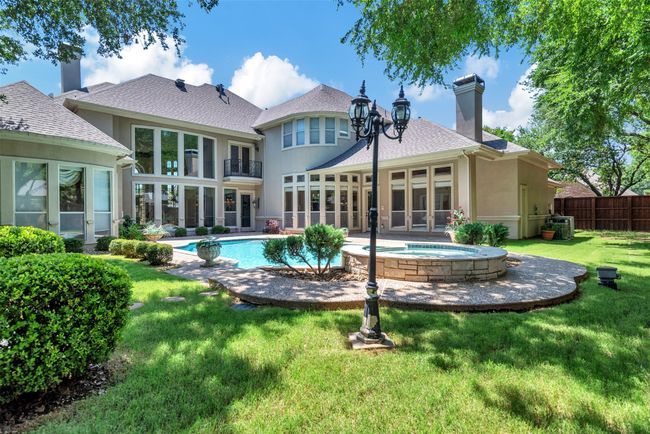 So many large windows are why the views from the house to the backyard are so amazing! Lots of grassy area around the pool and patio for kids and pets to play, and for even more lush gardens | Image 32