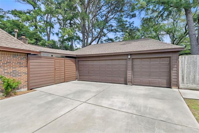 There is a three car garage with an auto garage door opener with plenty of driveway space to park additional vehicles. | Image 36