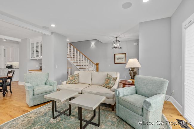 Open entertaining with lovely living area featuring 9' ceilings, engineered hardwood floors, and beautiful architectural details. | Image 8
