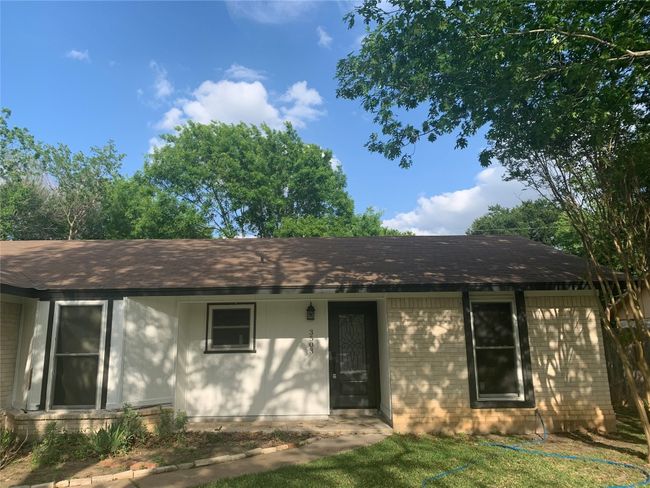 Ranch-style home with brick siding and roof with shingles | Image 4