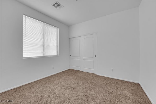Carpeted empty room featuring visible vents and baseboards | Image 14