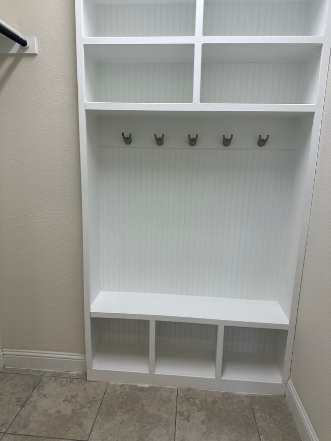 Mudroom with a textured wall and baseboards | Image 10