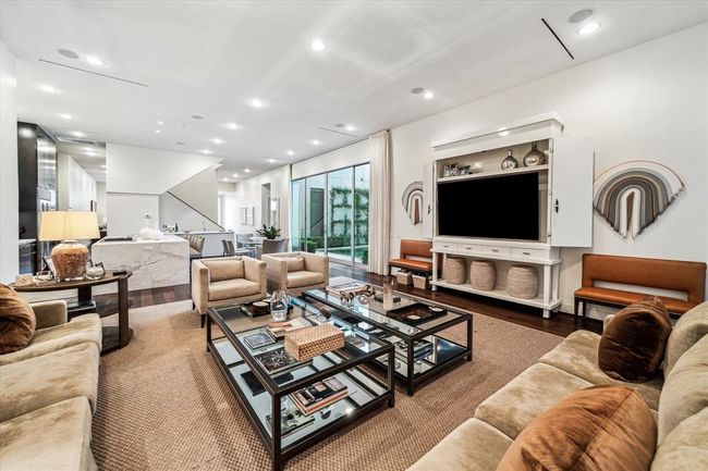 Seen from a back corner of the room, the generously sized space allows for a multitude of furniture arrangements to fit the owner's life style. | Image 17