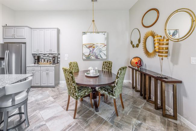 This space effortlessly transitions into the breakfast area, where intimate meals can be enjoyed. The entire property features elegant tile flooring, adding a touch of sophistication and ensuring easy maintenance. | Image 18