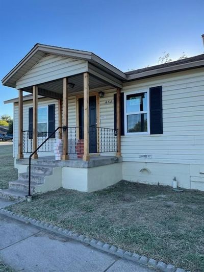 View of front of home with a front lawn and covered porch | Image 1