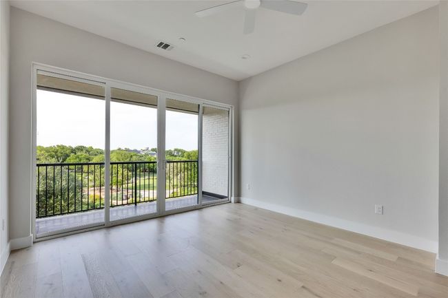 Unfurnished room with wood finished floors, a ceiling fan, and baseboards | Image 33
