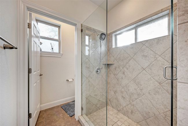 Full bath featuring plenty of natural light, a shower stall, and baseboards | Image 10