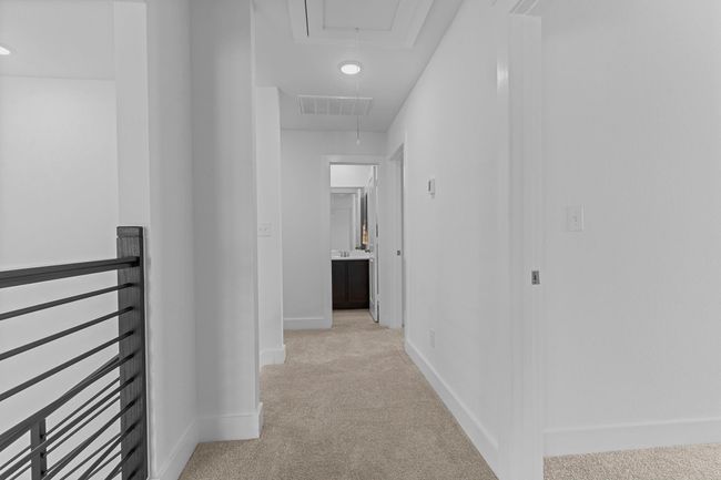 Upstairs hallway connects the secondary bedrooms and game room, with plush carpet underfoot and recessed lighting creating a bright, open feel. **Image Representative of Plan Only and May Vary as Built**. | Image 27