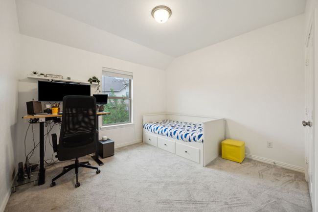 Carpeted bedroom featuring baseboards and lofted ceiling | Image 22