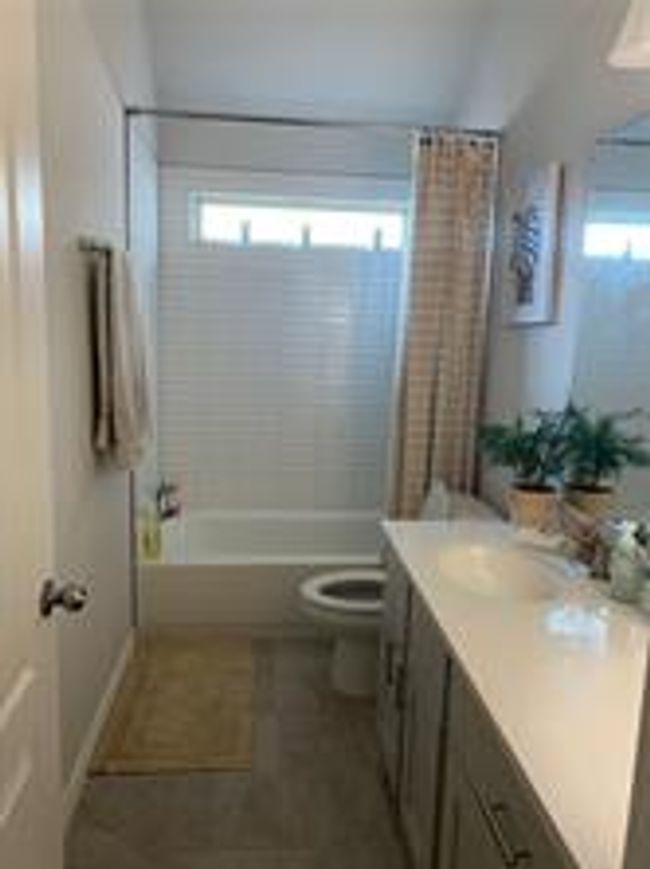 Bathroom featuring vanity and shower / tub combo with curtain | Image 18