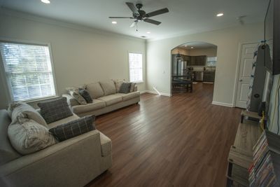 Fantastic open space and flow to the Kitchen from the Living Room. Lovely arched doorway separates the two rooms. NO CARPET! | Image 2