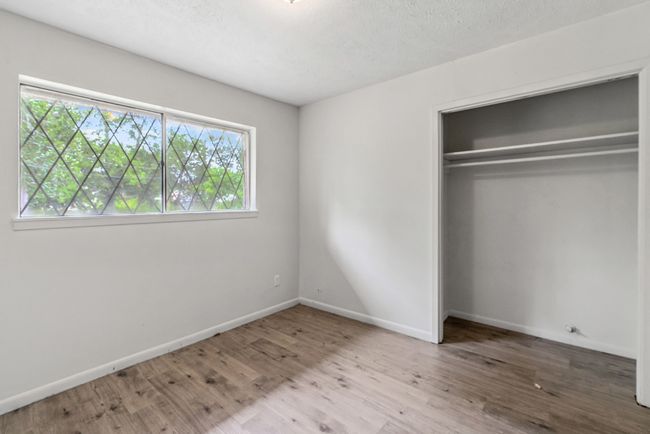 Unfurnished bedroom featuring wood finished floors and a closet | Image 14