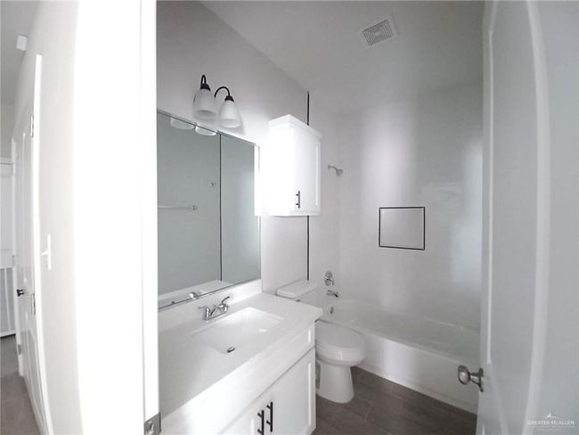 Full bathroom featuring toilet, vanity, and washtub / shower combination | Image 9