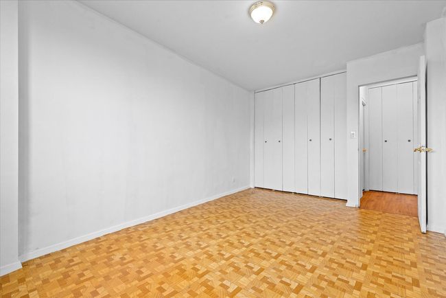 Unfurnished bedroom with baseboards and a closet | Image 13