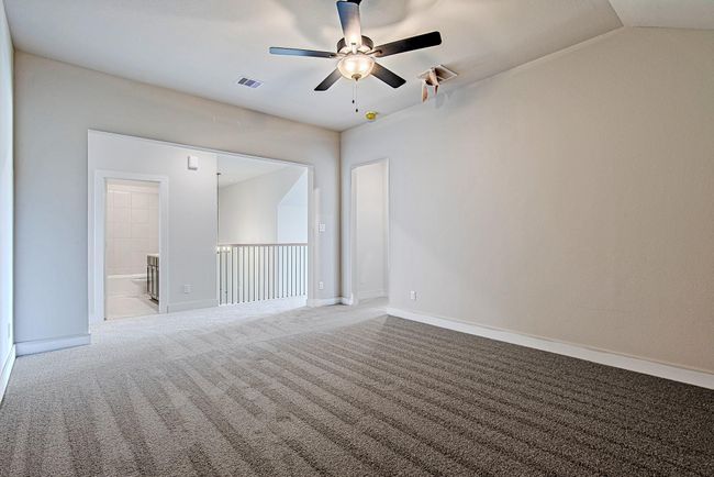 Spacious upstairs bonus area ideal for lounging, study, or play—with views overlooking the stair railing and easy access to the full bathroom. | Image 35