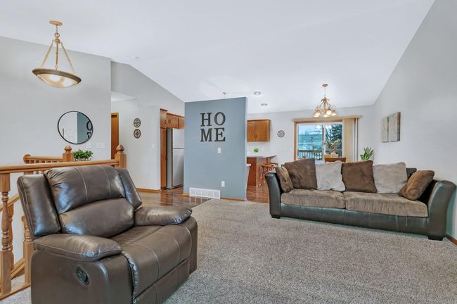 Livingroom with vaulted ceiling open to the dining area | Image 11