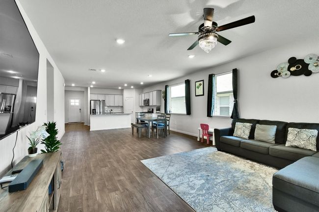 Living area featuring ceiling fan, recessed lighting, dark wood-style floors, and baseboards | Image 13