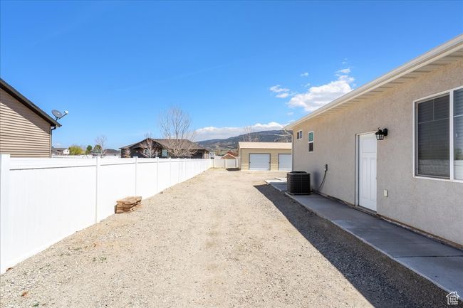 View of yard with central AC unit, fence, and a mountain view | Image 62