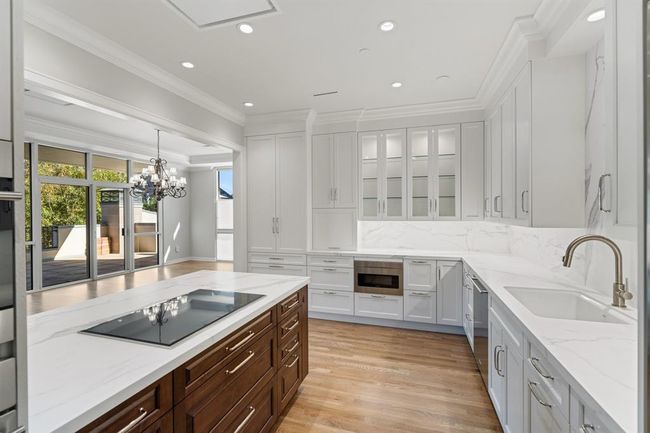 Glass front display cabinetry, smooth close, beautiful millwork and polished nickel hardware. | Image 8