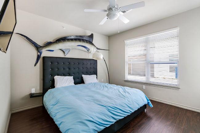 Bedroom featuring wood finished floors and ceiling fan | Image 21