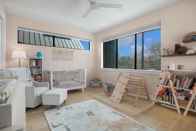 Second bedroom featuring multiple windows with skyline views | Image 23