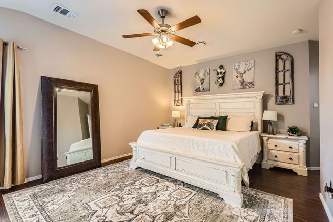 Bedroom with dark wood-style flooring and a ceiling fan | Image 10