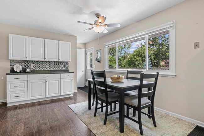 View of the additional cabinet space (perfect for a coffee bar and great storage!) and the door leading to the deck, patio and backyard. | Image 6