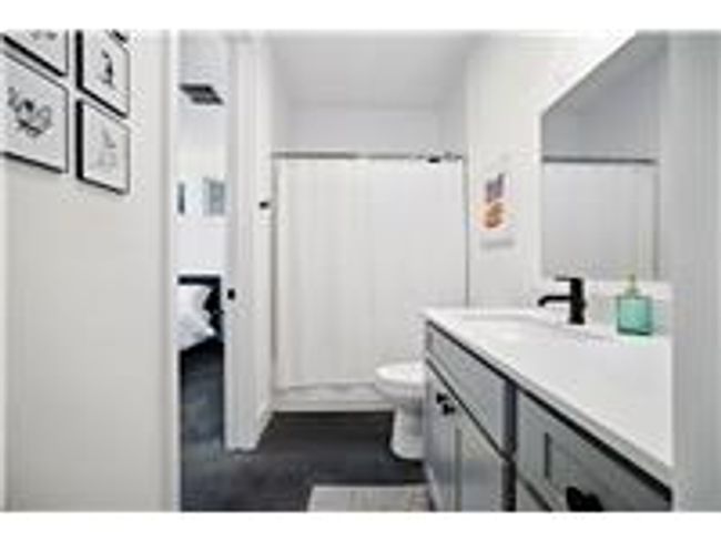 Full bathroom on main floor with concrete finished floors, and vanity | Image 11