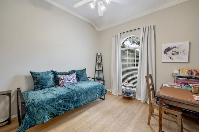 4th Bedroom or study featuring Double privacy doors, crown molding, wood finished floors, baseboards, and ceiling fan | Image 18