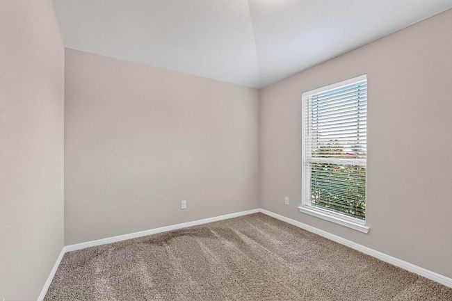 Spare room featuring carpet flooring and lofted ceiling | Image 31
