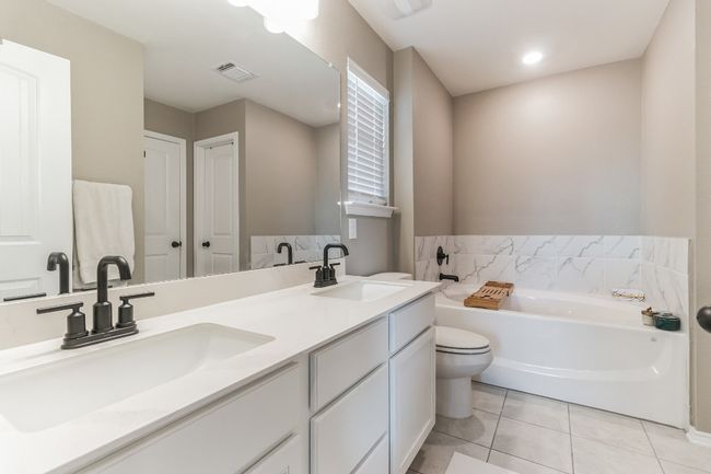 Bathroom featuring double vanity, a garden tub, and tile patterned flooring | Image 21