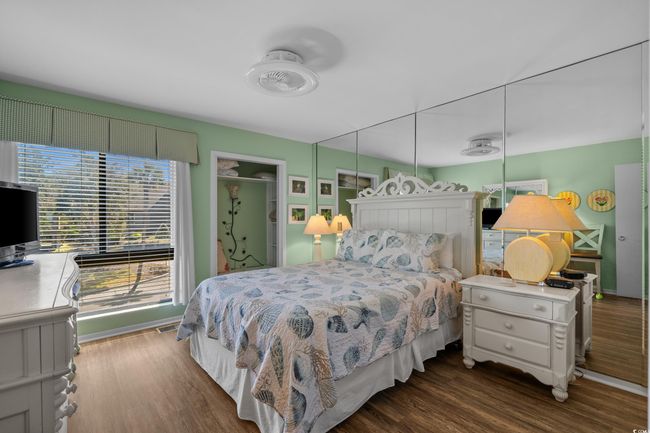 Primary Bedroom with visible vents and wood finished floors | Image 22