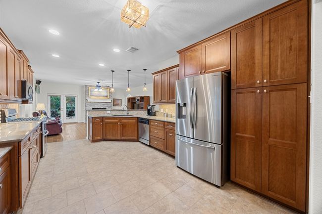 This view shows how truly large this kitchen is! Look at all of the storage! | Image 16