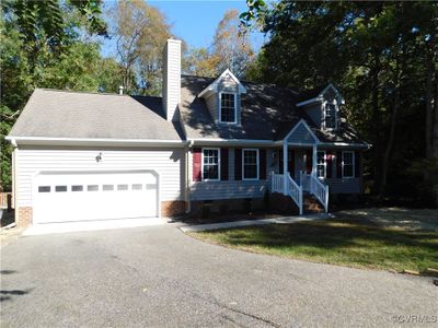 Cape cod home with a porch and a garage | Image 1