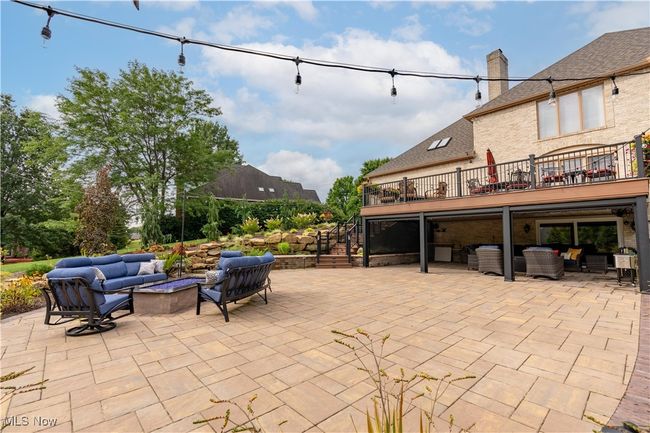 View of patio with an outdoor living space with a fire pit, a deck, and stairs | Image 7
