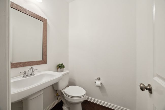 Half bathroom with toilet and baseboards | Image 11
