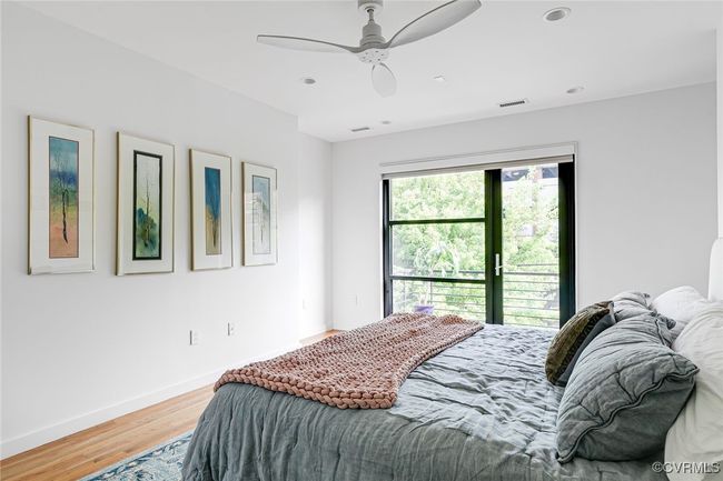 The clean palette, hardwoods and ceiling fan create a serene sanctuary. | Image 31