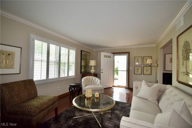 Living room featuring ornamental molding, wood finished floors, and baseboards | Image 7