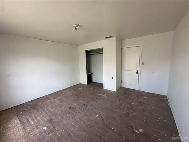 Unfurnished bedroom featuring dark hardwood / wood-style floors and a closet | Image 16