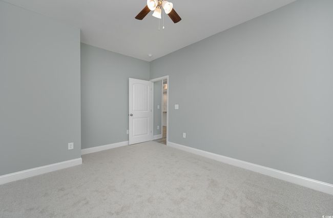 Carpeted spare room with ceiling fan | Image 12