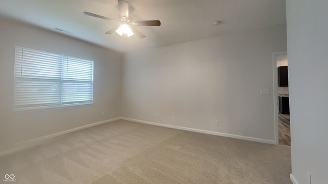 empty room featuring light colored carpet, visible vents, a ceiling fan, and baseboards | Image 8