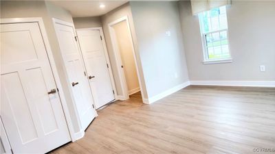 Unfurnished bedroom with light hardwood / wood-style flooring | Image 2