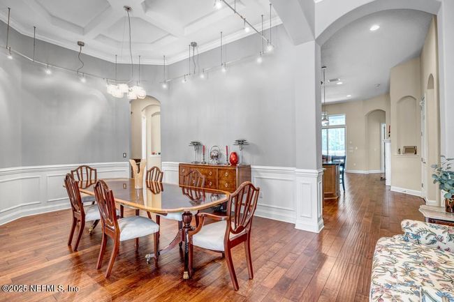 Huge formal dining room with coffered ceiling and art lighting | Image 9