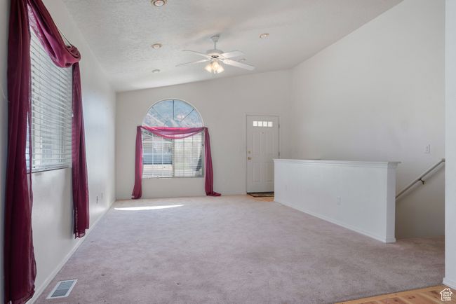 Spare room featuring carpet floors, vaulted ceiling, and a ceiling fan | Image 5