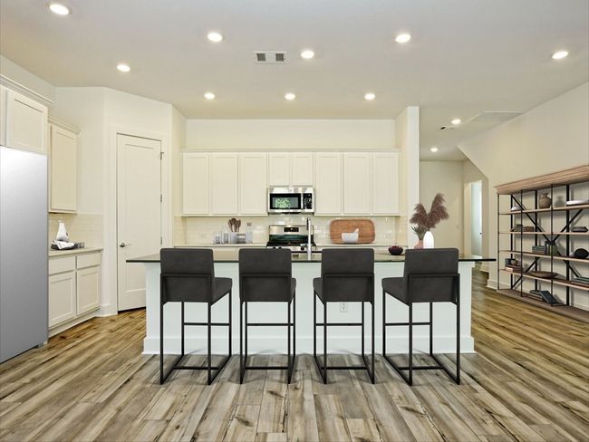 Kitchen with stainless steel appliances, light wood-type flooring, tasteful backsplash, white cabinetry, and recessed lighting | Image 8