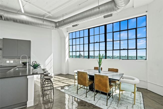 Dining room featuring concrete flooring and visible vents | Image 9