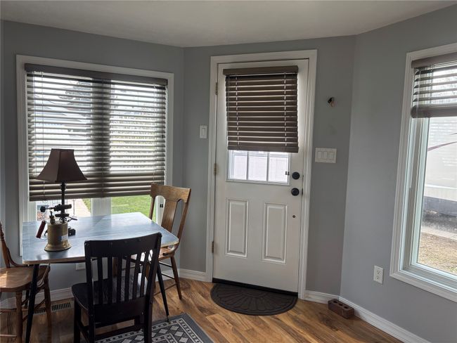 Dining area with wood finished floors and baseboards | Image 11