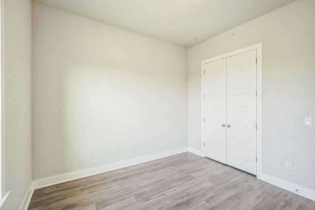 Unfurnished bedroom featuring light wood-type flooring, a closet, and baseboards | Image 10